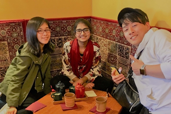 Photo of three international students posing in a Pittsburgh tea shop