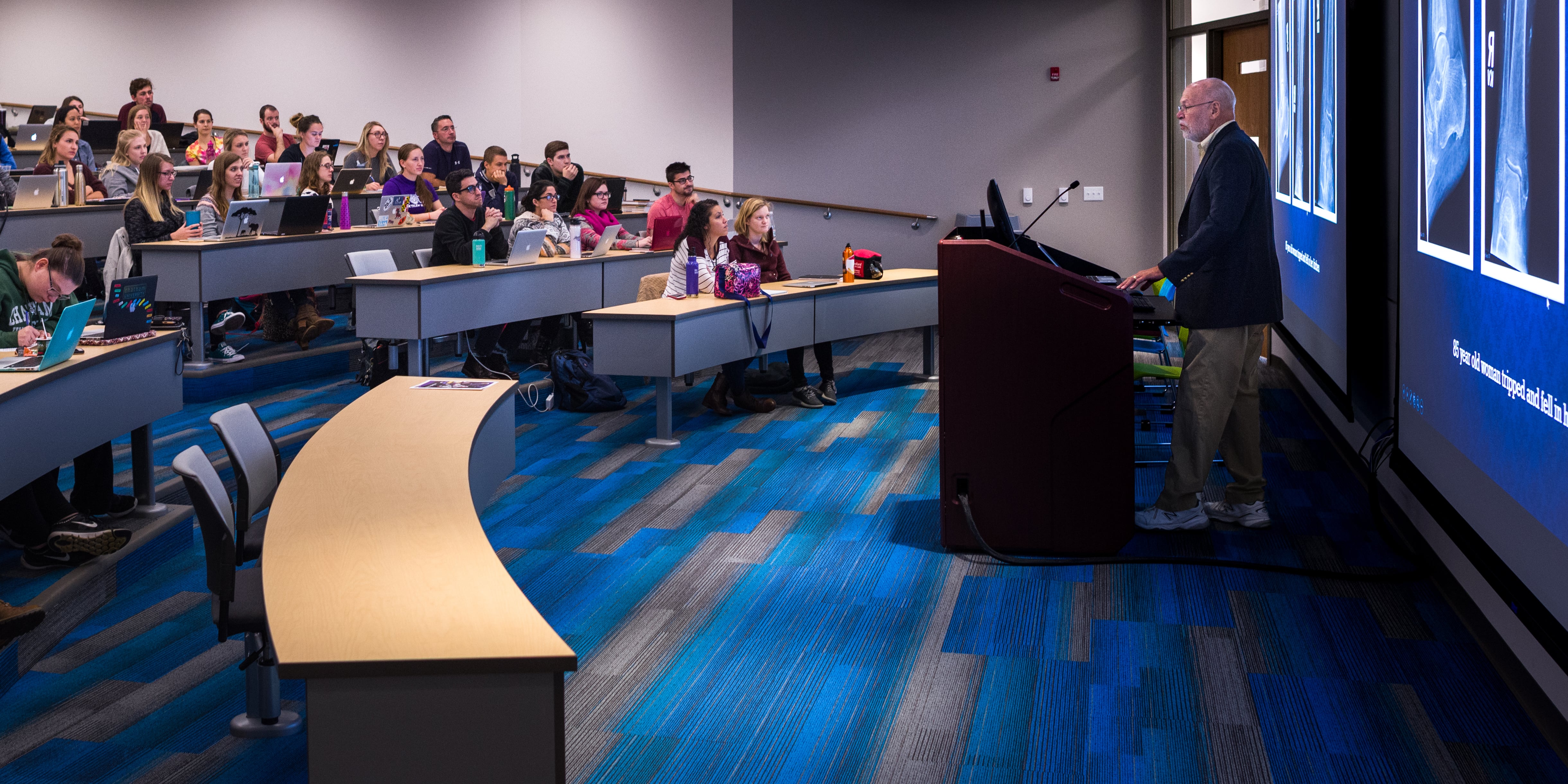 Photo of a professor teaching a classroom of Chatham University students in an auditorium at the Eastside campus. 