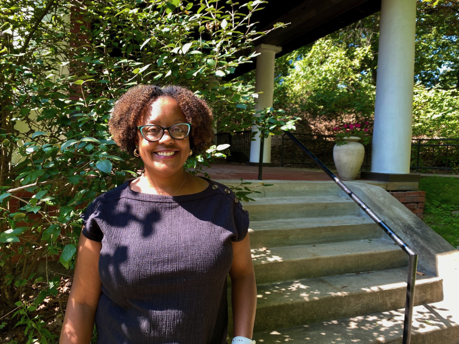 Portrait of Sakena Jwan Washington standing in front of greenery on Chatham University Shadyside Campus