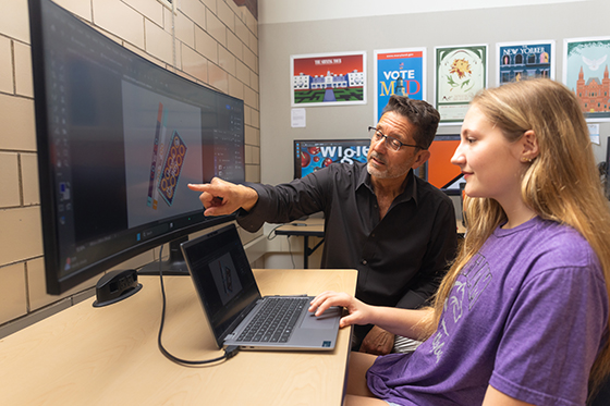 Chatham faculty member helps a student at a computer
