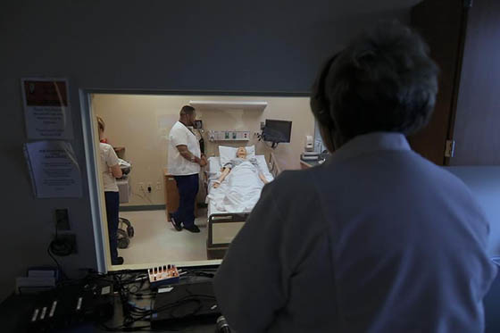 Close-up photo of a nurse preparing to draw blood from a seated patient