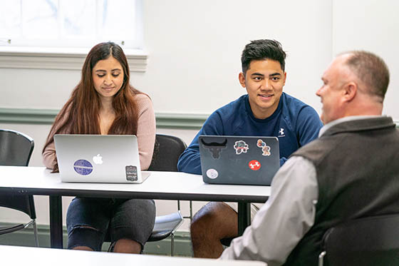 Photo of two Chatham University students paying attention to a lecture