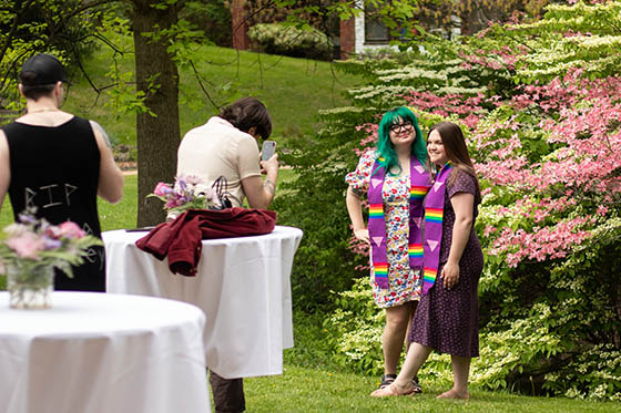 Photo of Chatham University graduates at the Lavender Graduation ceremony, wearing matching purple stoles with rainbow