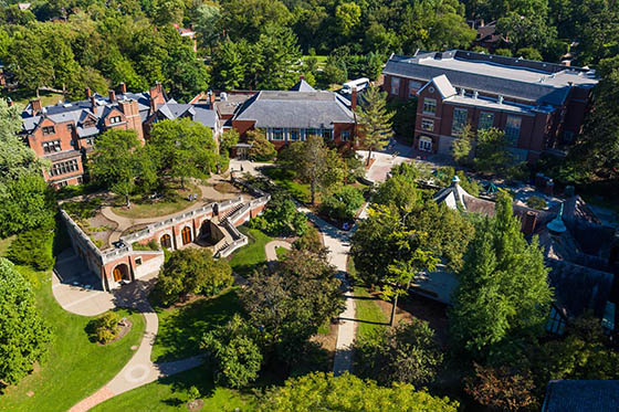Close-up photo of a student writing in a notebook in the library