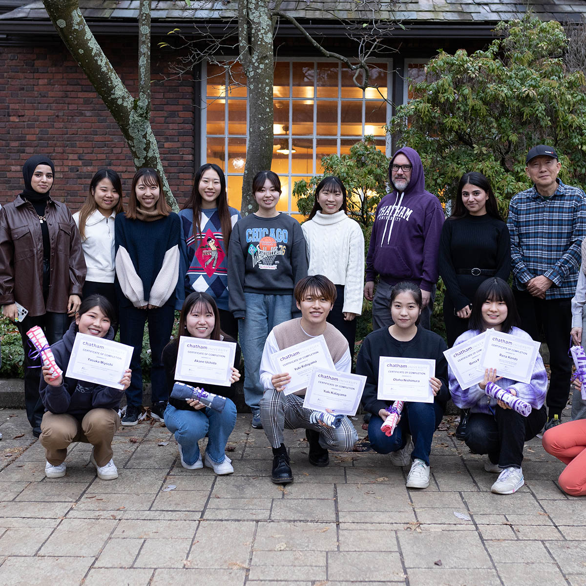 Photo of a group of international students holding their certificates of completion of the English Language Program