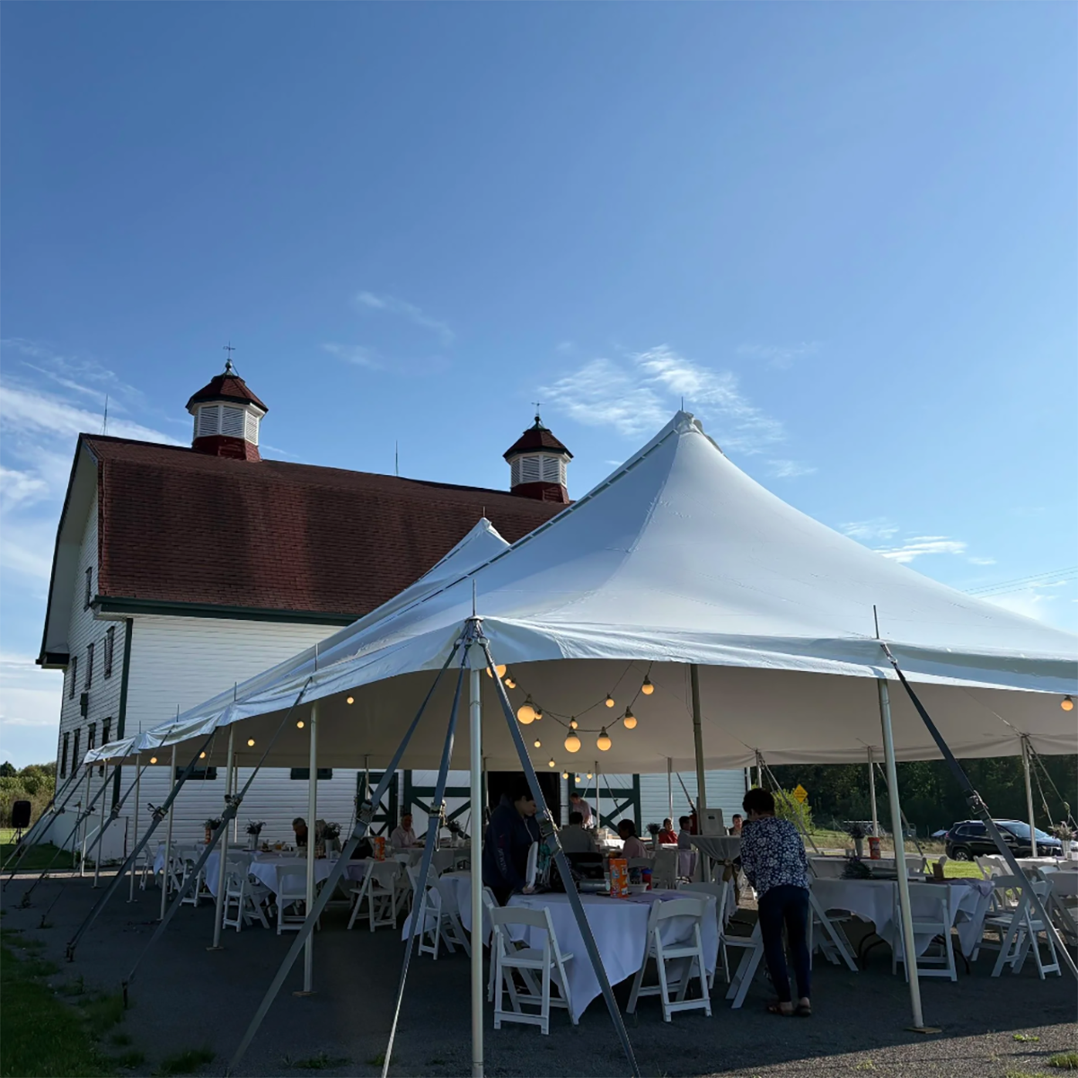Diners gather in the big tent under a blue sky at Eden Hall Farm during Farm to Fork 2025