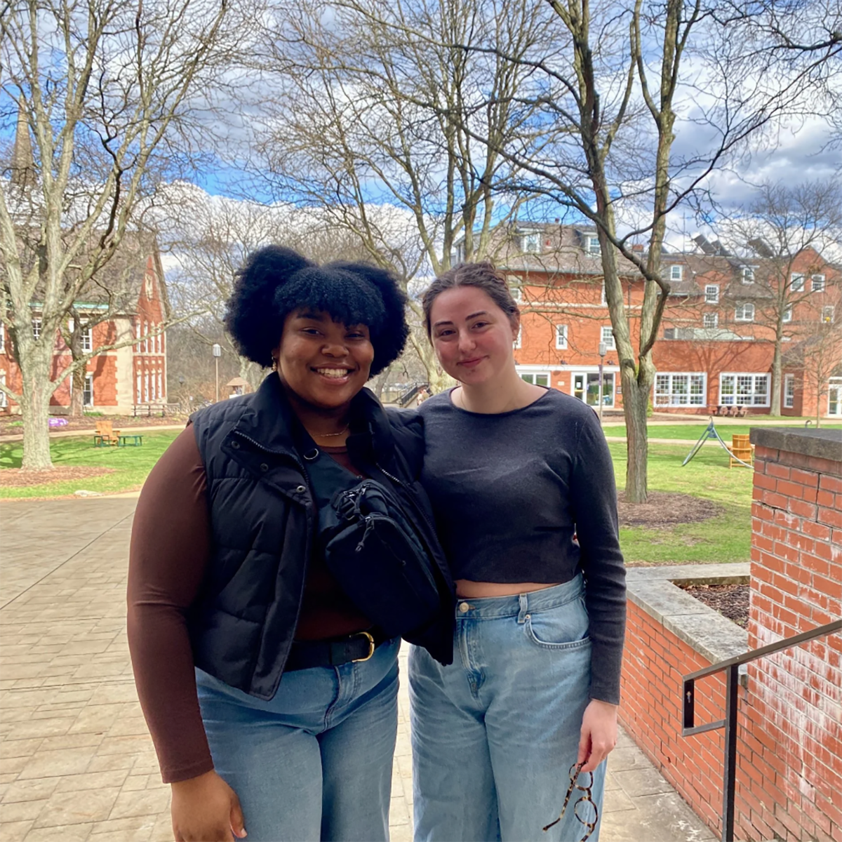 Lyn Burton (left) and Jordan Dahl pose for a photo on library steps