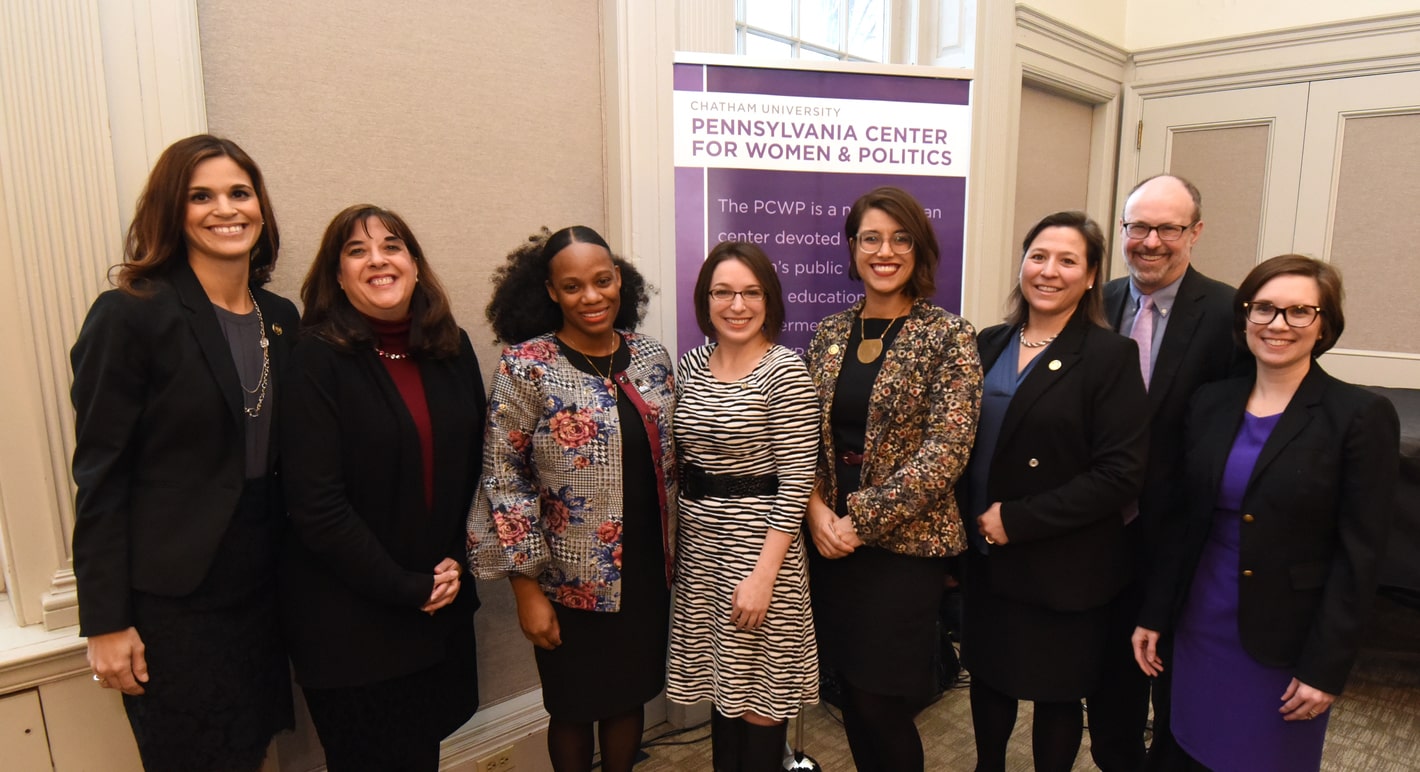 Photo of Chatham's president with seven women, smiling at the camera.