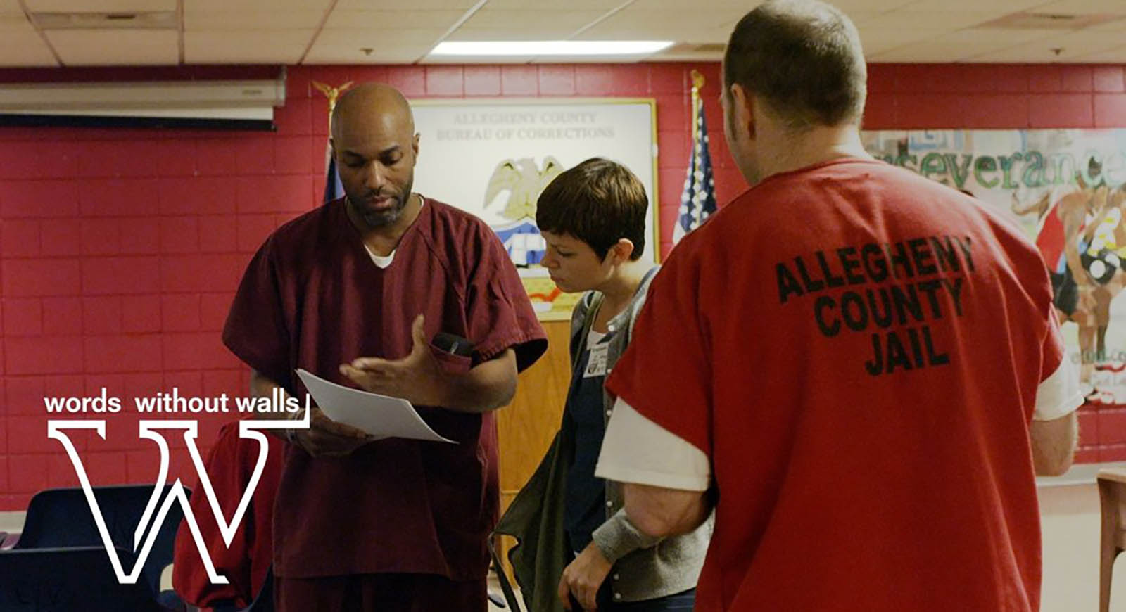 Photo from Allegheny County Jail, of incarcerated people working with a Chatham University student volunteering through Words Without Walls.