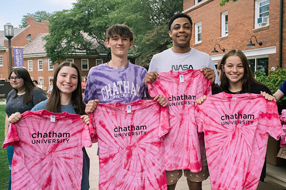 Undergraduate Chatham students on Shadyside Campus holding t-shirts