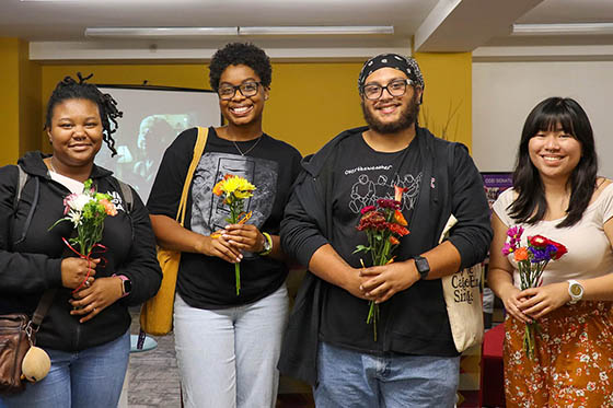Chatham University students at Family Dinner holding flowers