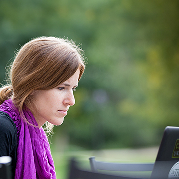 Chatham online student works on her laptop outside