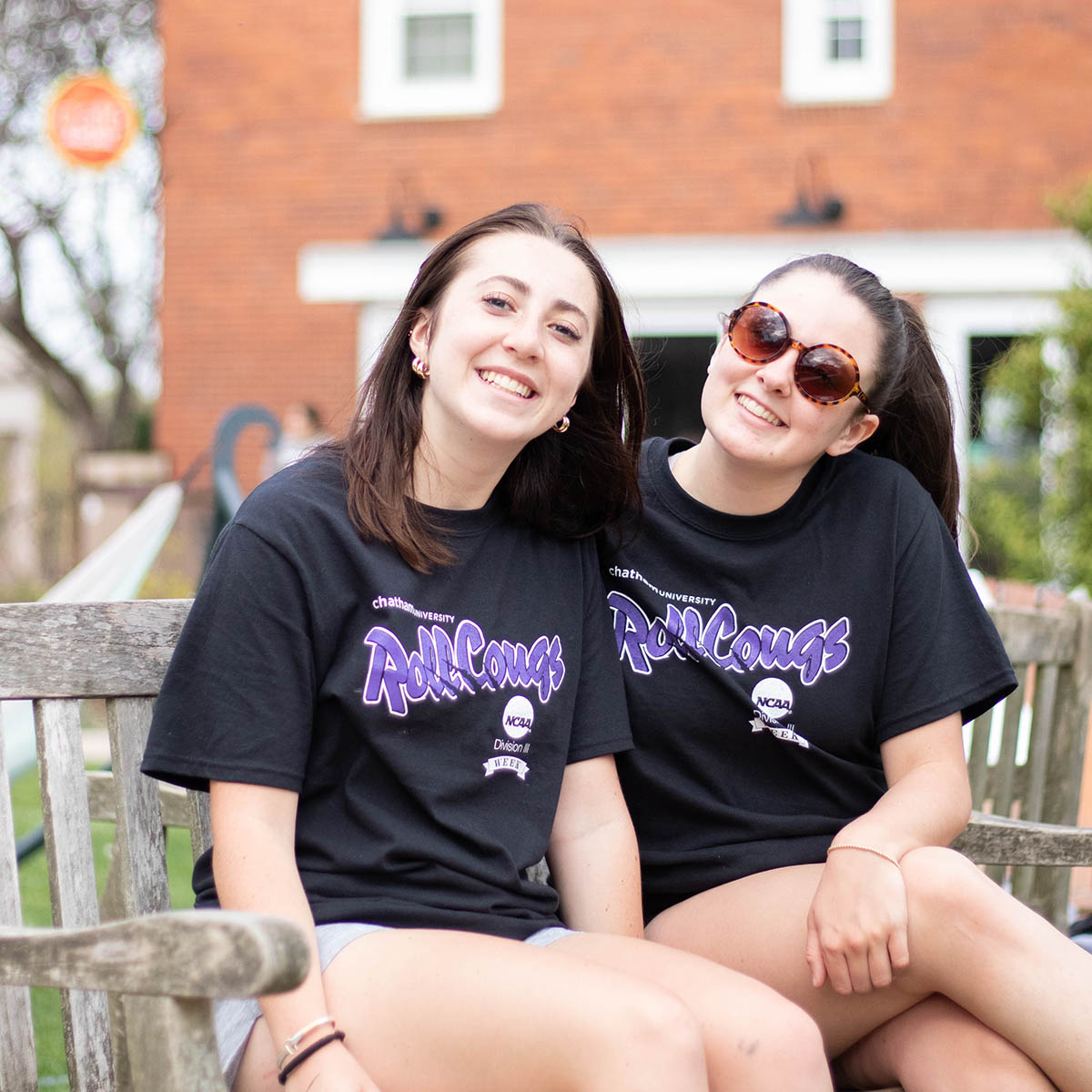 Two Chatham students smile and pose for a photo on the Quad