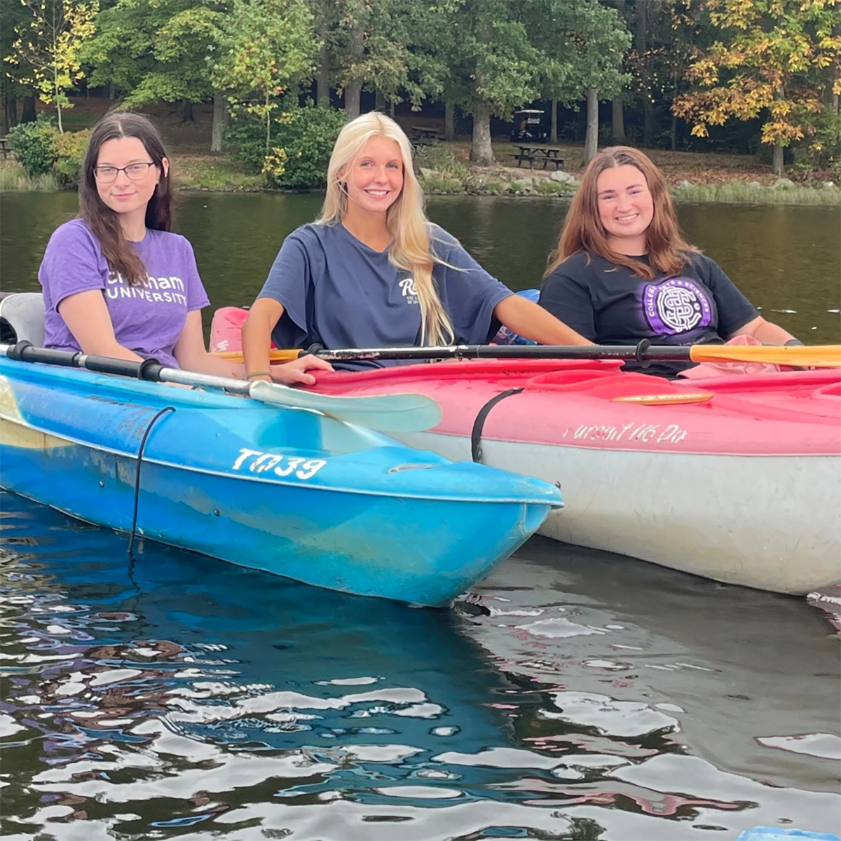 Megan Poff '26, Madison Long '26, and Samantha Schury '25 kayak on the lake at Keystone State Park