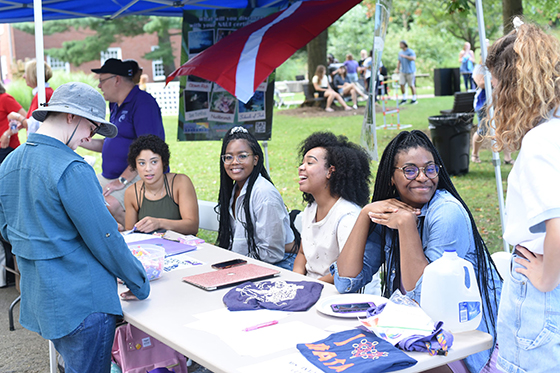 Photo of Chatham University students at a club table during activities fair