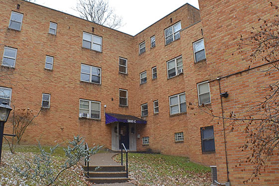 Two Chatham undergraduate students at the door of their dorm room