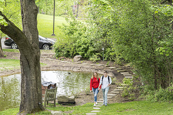 Two Chatham undergraduate students at the door of their dorm room